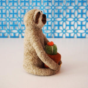 Needle felted sloth with blooming cactus plant